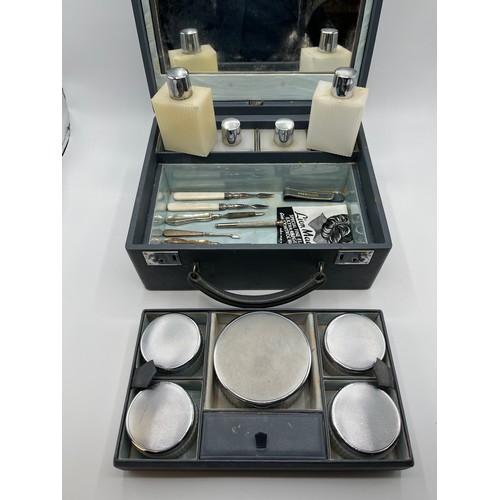 84 - Asprey London . A mid 20th century faux leather ladies dressing table travel case. Complete with ful... 