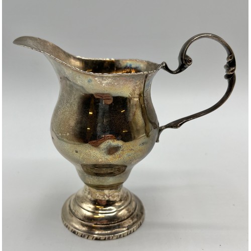 91 - A sterling silver cream jug on square base by George Nathan and Ridley Hayes, Chester, together with... 