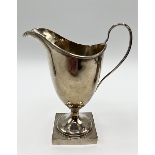 91 - A sterling silver cream jug on square base by George Nathan and Ridley Hayes, Chester, together with... 