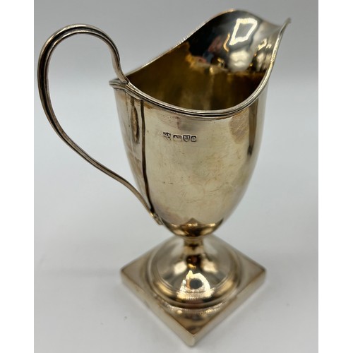 91 - A sterling silver cream jug on square base by George Nathan and Ridley Hayes, Chester, together with... 