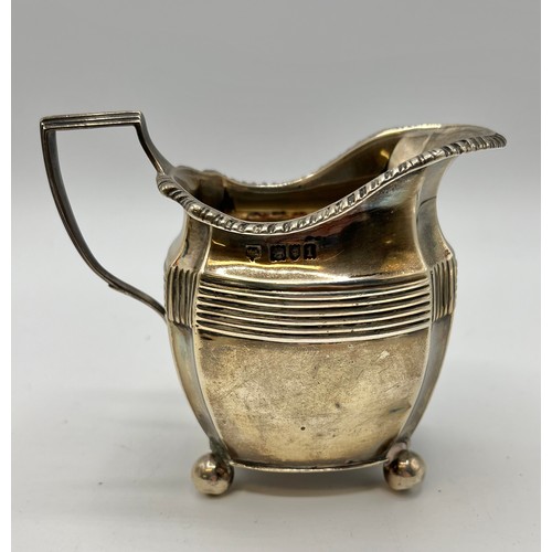 91 - A sterling silver cream jug on square base by George Nathan and Ridley Hayes, Chester, together with... 