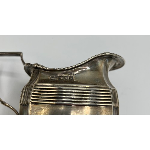 91 - A sterling silver cream jug on square base by George Nathan and Ridley Hayes, Chester, together with... 