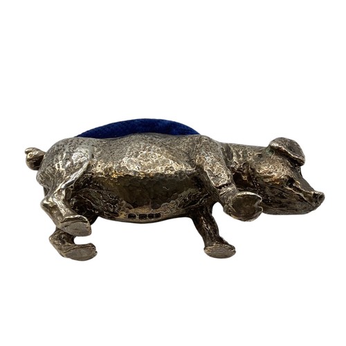 93 - A collection of small sterling silver items to include a weighted pig pin cushion , a pepperette in ... 