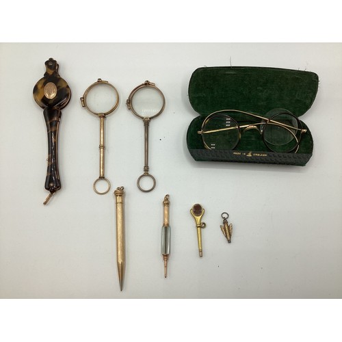 87 - A collection of unmarked yellow metal items to include a pencil watch fob set with carnelian and blo... 