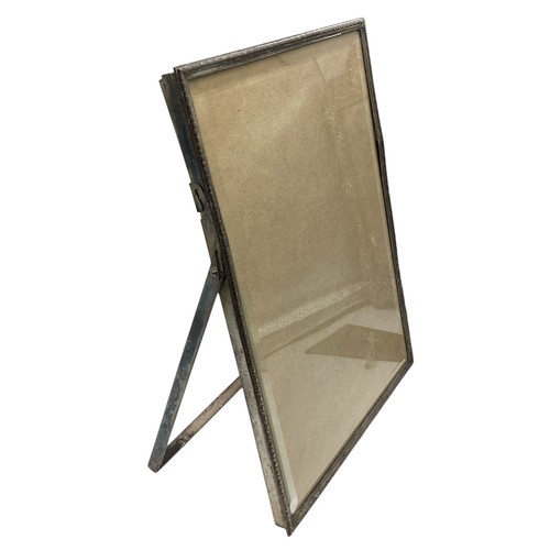 92 - A sterling silver mounted  easel backed dressing table mirror 31cm x 24cm, together with three unmar... 