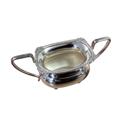 101 - A collection of silver plated wares to include a three piece tea set , Taza, sauce boat etc.