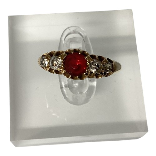 24 - An 18ct gold ruby and diamond ring. central round free cut ruby with old cut diamond accents. Size M... 