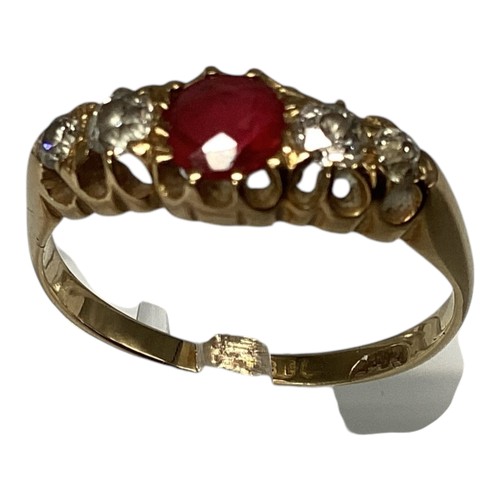 24 - An 18ct gold ruby and diamond ring. central round free cut ruby with old cut diamond accents. Size M... 