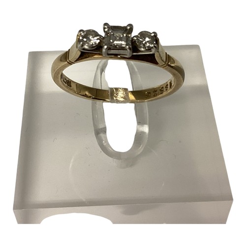 25 - An 18ct gold and platinum three stone diamond ring. Central square cut diamond with brilliant cut ac... 