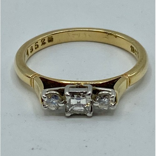 25 - An 18ct gold and platinum three stone diamond ring. Central square cut diamond with brilliant cut ac... 