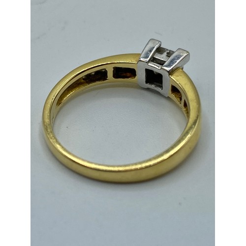 79 - An 18ct gold and diamond ring. Centrally set with four square cut diamonds and channel set single cu... 