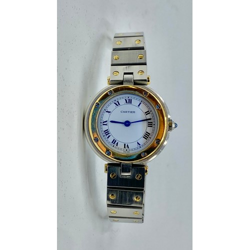 128 - Cartier. A Santos de Cartier yellow and white metal ladies wristwatch. 25mm case with white face and... 