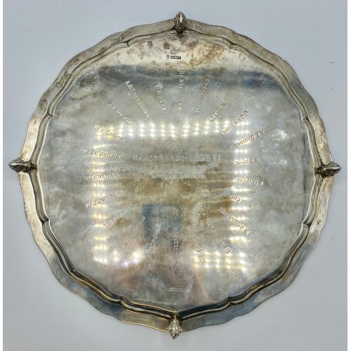 115 - A large sterling silver circular tray  raised on four shell feet. Engraved to underside 'To Major RH... 