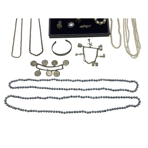 109 - A collection of silver and white metal items to include a sterling silver coin set bracelet, a white... 