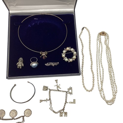 109 - A collection of silver and white metal items to include a sterling silver coin set bracelet, a white... 