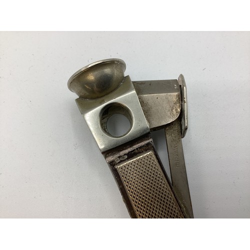 105 - A 925 silver mounted cigar cutter together with a white metal Dunhill Tallboy table lighter A Gucci ... 