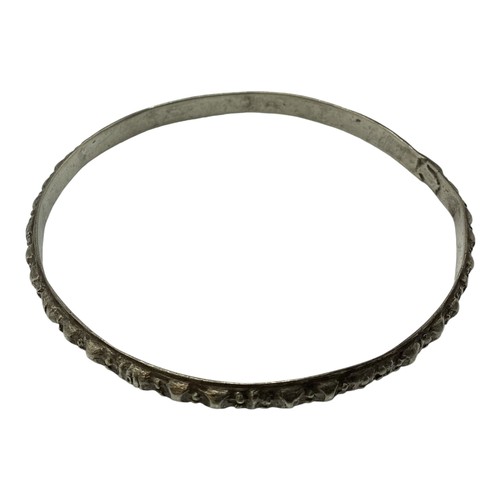 131 - A collection of South Asian unmarked white metal bangles. 117g together with a white metal propellin... 