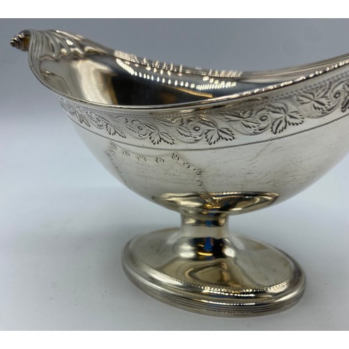 118 - A sterling silver boat shaped bowl with scroll finials on stepped foot with chased decoration by Hen... 