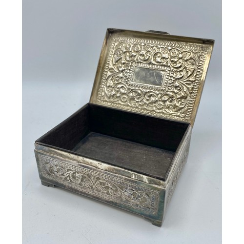 110 - An Anglo Indian white metal box marked T100 to base with floral repousse decoration and cedar lining... 