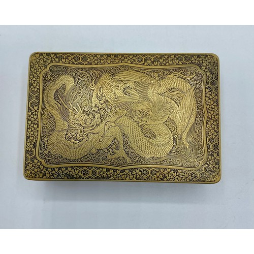 111 - A yellow metal Japanese Damascene style box. Dragon and Phoenix to lid with signature to base. 8cm x... 