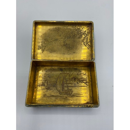 111 - A yellow metal Japanese Damascene style box. Dragon and Phoenix to lid with signature to base. 8cm x... 