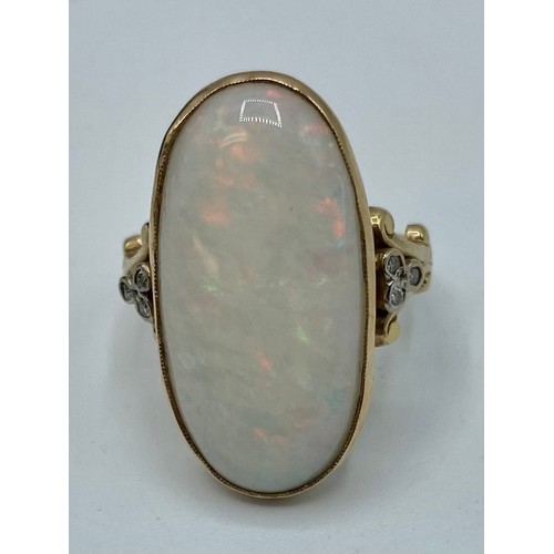 133 - A 9 ct gold Opal and Diamond dress ring oval cabochon cut opal 25 mm x 14mm with single cut diamond ... 