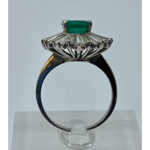 135 - Unmarked white metal Emerald and Diamond halo ring central oval free cut Emerald 8mm x 5mm approx wi... 