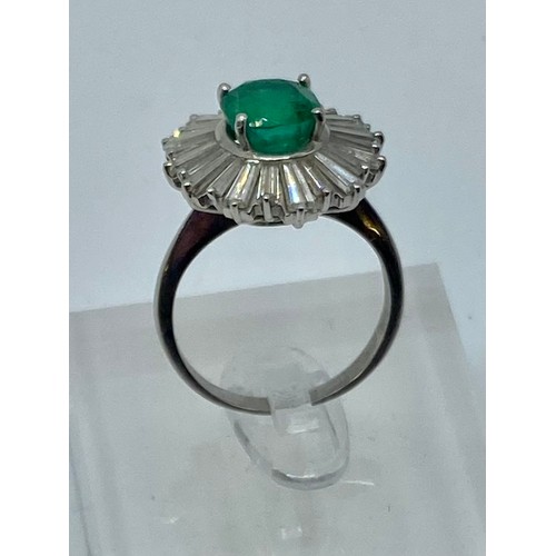 135 - Unmarked white metal Emerald and Diamond halo ring central oval free cut Emerald 8mm x 5mm approx wi... 