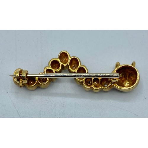 137 - An 18 ct gold and diamond caterpillar broach with ruby set eyes 32 mm, 6.6 g