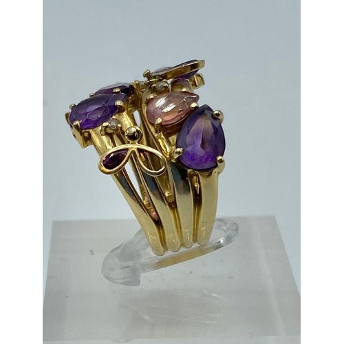 140 - An 18 ct gold Amethyst and diamond dress ring set with four free cut amethysts with 3 amethyst set t... 