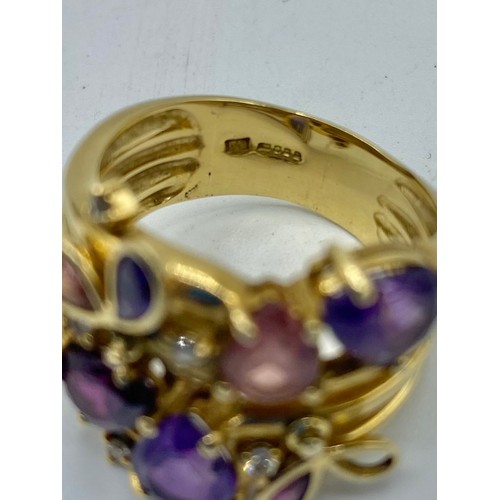 140 - An 18 ct gold Amethyst and diamond dress ring set with four free cut amethysts with 3 amethyst set t... 