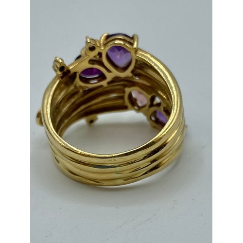 140 - An 18 ct gold Amethyst and diamond dress ring set with four free cut amethysts with 3 amethyst set t... 