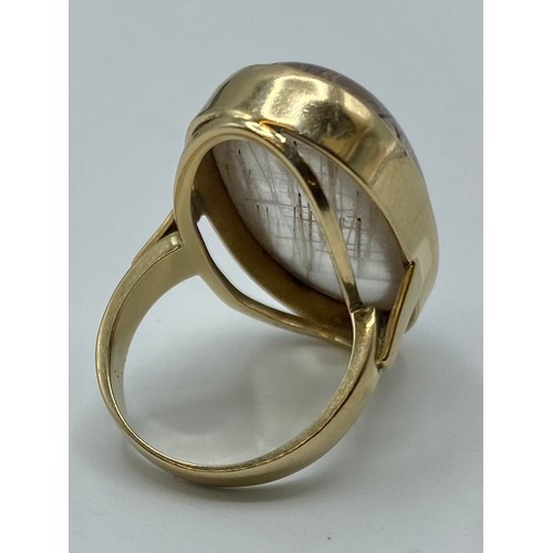 138 - A 9 ct gold and rutilated quartz dress ring 12.1 g size P.  Two tiny chips to centre of stone, not v... 