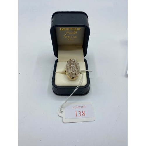 138 - A 9 ct gold and rutilated quartz dress ring 12.1 g size P.  Two tiny chips to centre of stone, not v... 