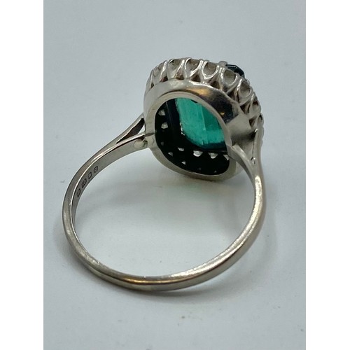 141 - An 18 ct white gold Emerald and Diamond dress ring central step cut Emerald, 13 x 9 mm approx with a... 