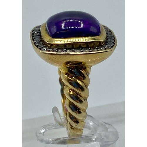 154 - A gilt silver and amethyst ladies dress ring set with free cut cabochon amethyst and a surround of s... 