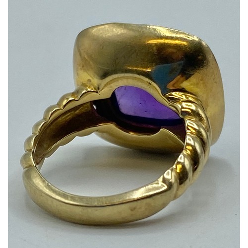 154 - A gilt silver and amethyst ladies dress ring set with free cut cabochon amethyst and a surround of s... 