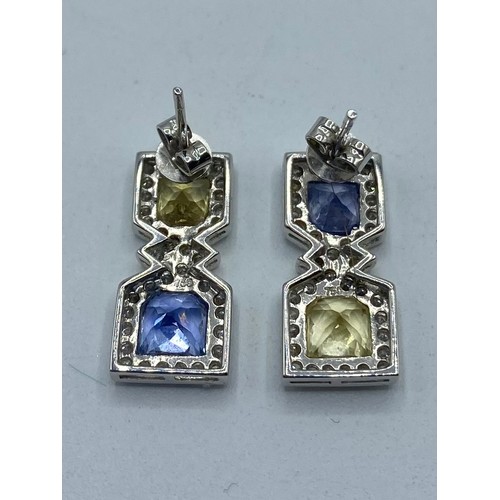 148 - A pair of 18ct white gold sapphire,  fancy yellow sapphire and diamond drop earrings/ Each set with ... 