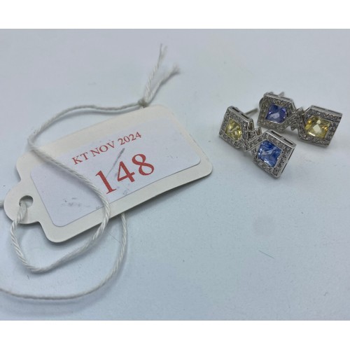 148 - A pair of 18ct white gold sapphire,  fancy yellow sapphire and diamond drop earrings/ Each set with ... 