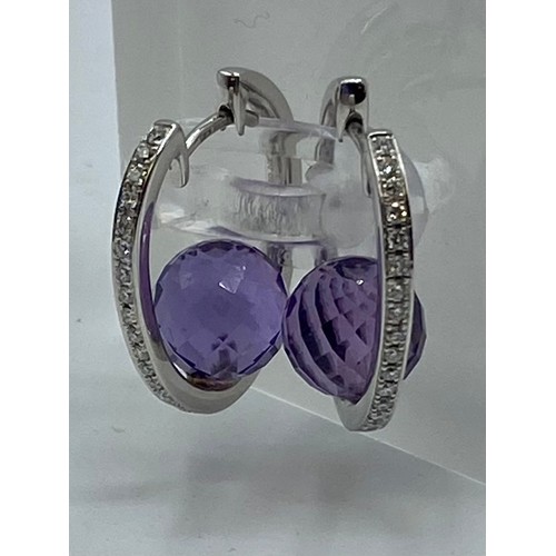 149 - A pair of 18ct white gold amethyst and diamond ear rings. 6.8g.