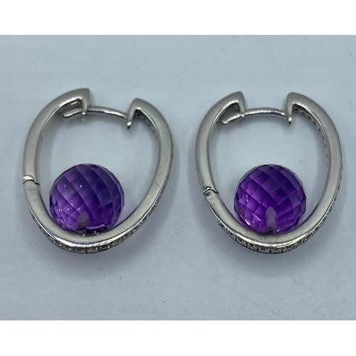 149 - A pair of 18ct white gold amethyst and diamond ear rings. 6.8g.