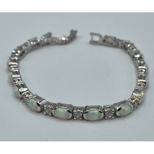 152 - A Sterling silver 18cm. 14.4g silver and a reconstituted opal line bracelet.