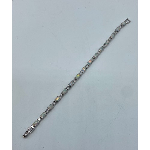 152 - A Sterling silver 18cm. 14.4g silver and a reconstituted opal line bracelet.