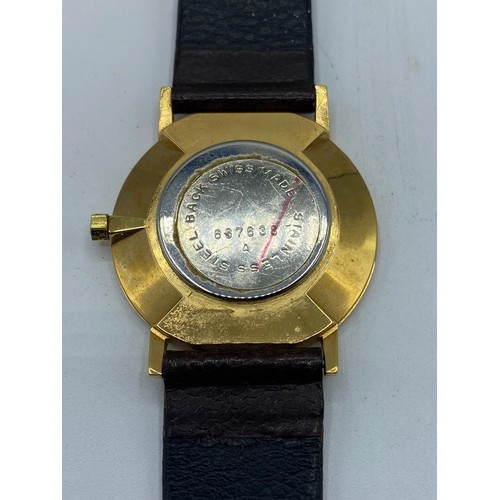 151 - An unmarked yellow metal gentleman's wrist watch Taj Group with quartz movement on black leather str... 