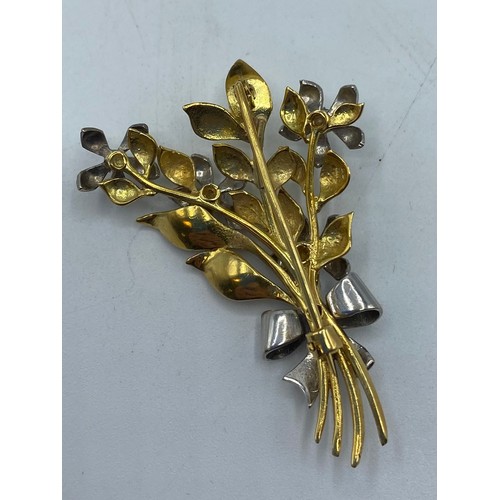 142 - An 18 ct yellow and white gold floral spray broach set with 6 single cut diamonds, 11.4 g