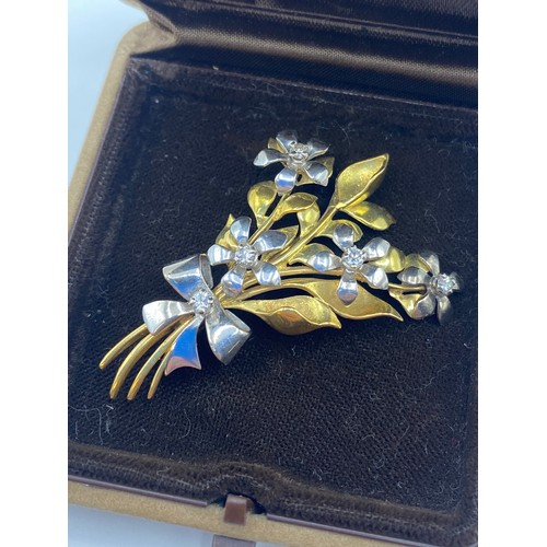 142 - An 18 ct yellow and white gold floral spray broach set with 6 single cut diamonds, 11.4 g