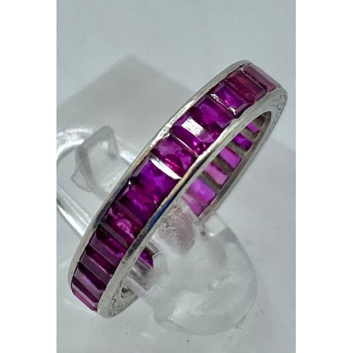 170 - A platinum and ruby set full eternity ring. 32 channel set baguette cut rubies. Size M. 3.6g. (condi... 