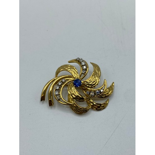 172 - An 18ct gold sapphire and diamond spray brooch. Central mixed cut sapphire with 14 single cut diamon... 