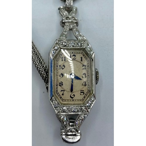 175 - A ladies platinum and diamond set cocktail watch. Octagonal dial with Arabic markers and blued steel... 