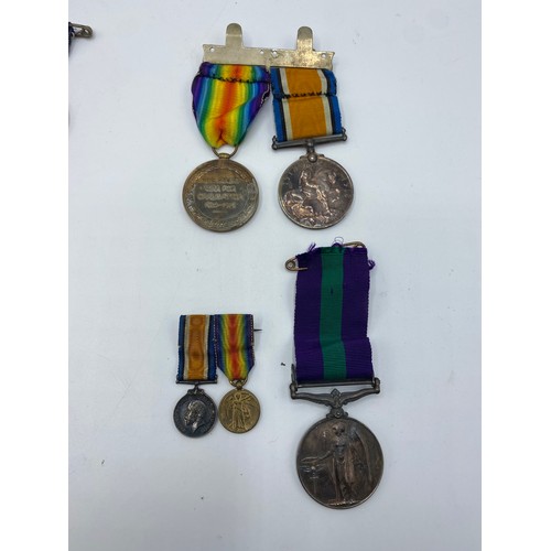 166 - A collection of medals and cap badges. WWI medals to Pte J. Cross.